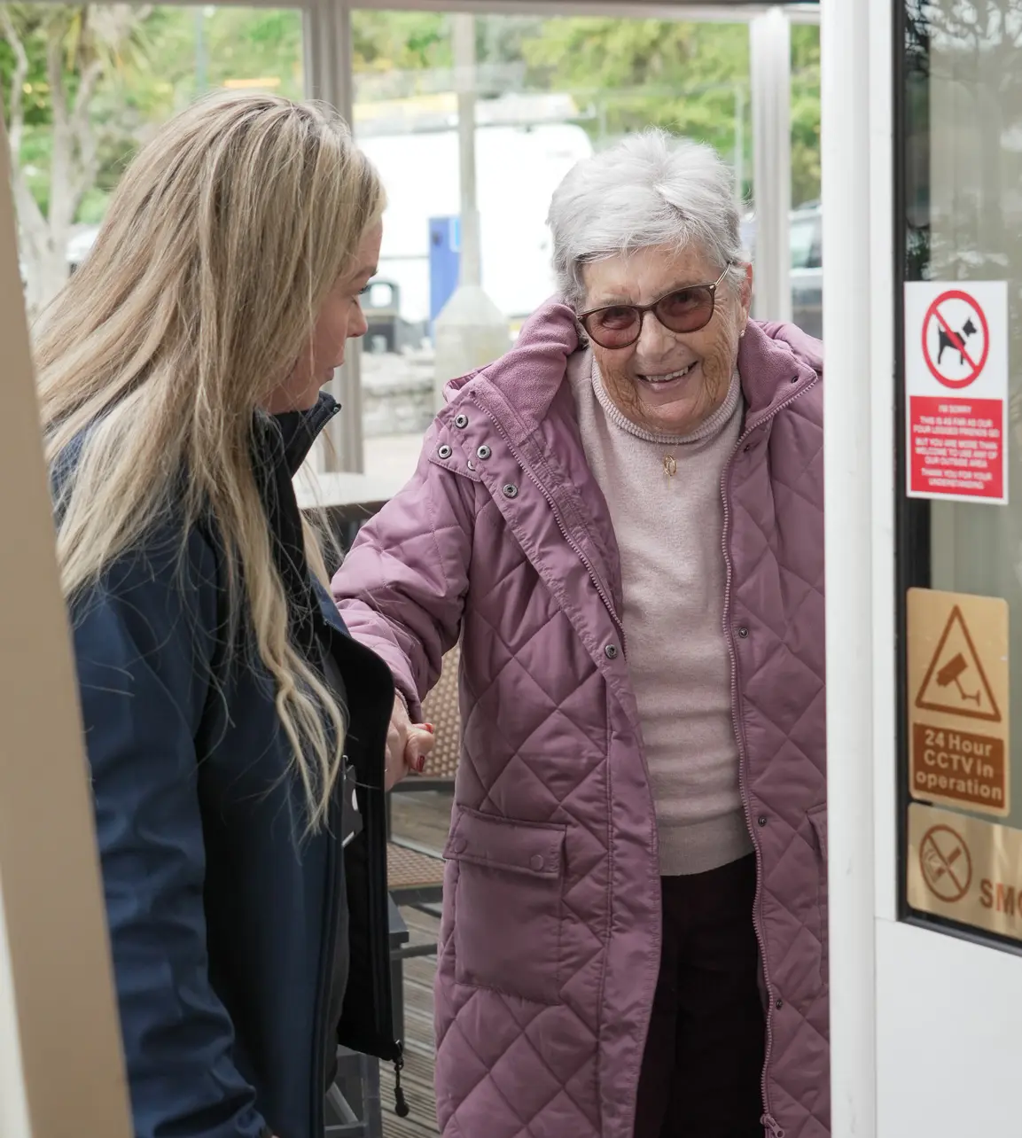 A Skyline carer greeting a client at her front door