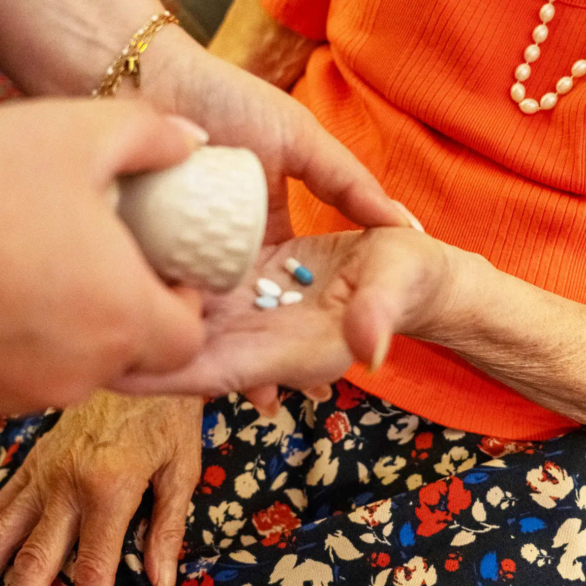 A carer helping with medication at home